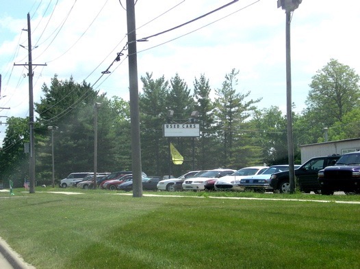 2 miles after Zeeb, this used car dealer will be on your right.  You will turn right immediately after this.